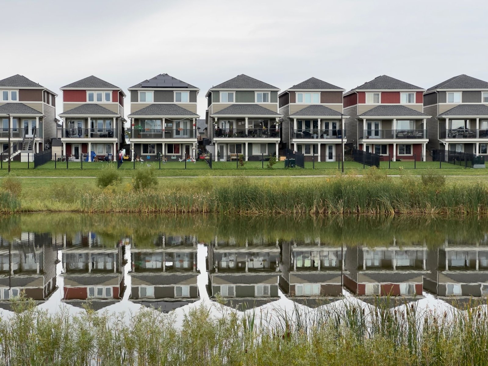 modern row of houses reflected in water